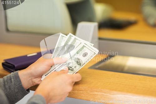 Image of hands with money at bank or currency exchanger