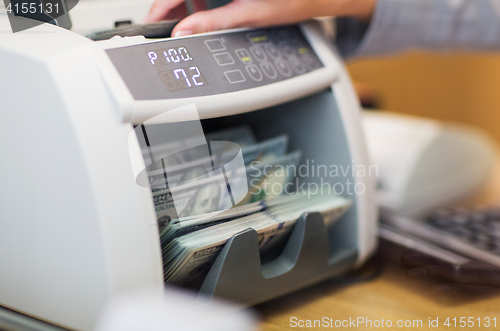 Image of dollars in electronic money counter at bank office