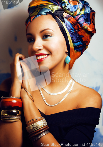 Image of beauty bright african woman with creative make up, shawl on head