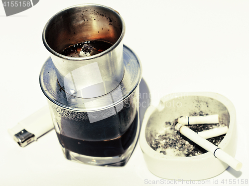 Image of vietnamese cofe and cigarette with ashtray isolated on white clo