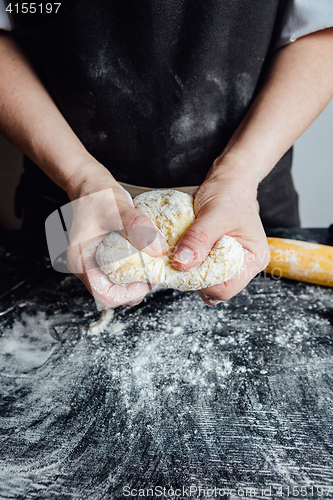 Image of Person covering pastry with flour