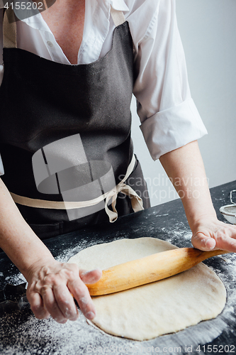 Image of Person rolling homemade cookie dough