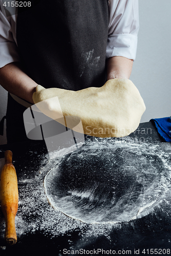 Image of Person rolling homemade cookie dough