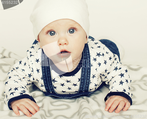 Image of little cute baby toddler on carpet isolated close up smiling ado