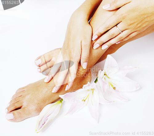 Image of manicure pedicure with flower lily close up isolated on white pe