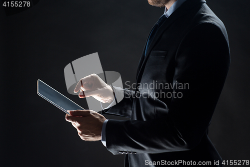 Image of close up of businessman with transparent tablet pc