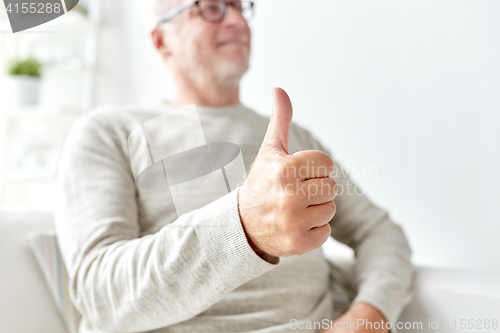 Image of senior man showing thumbs up