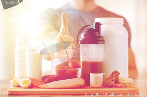 Image of man with protein food showing thumbs up