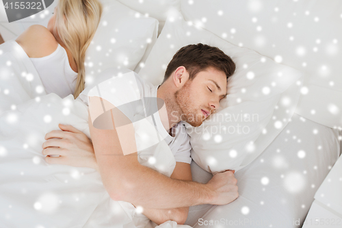 Image of couple sleeping in bed at home