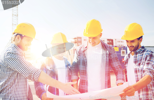 Image of group of builders with tablet pc and blueprint