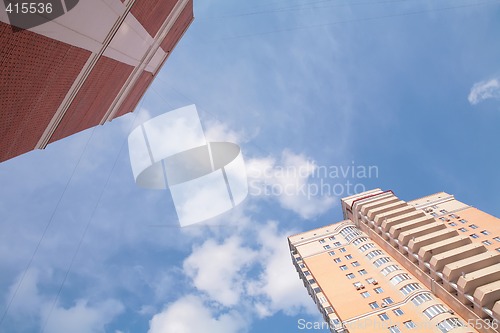 Image of sky under red skyscrapers