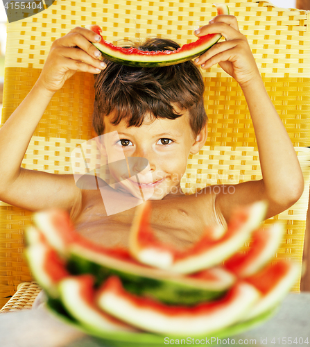 Image of cute young little boy with watermelon crustes smiling