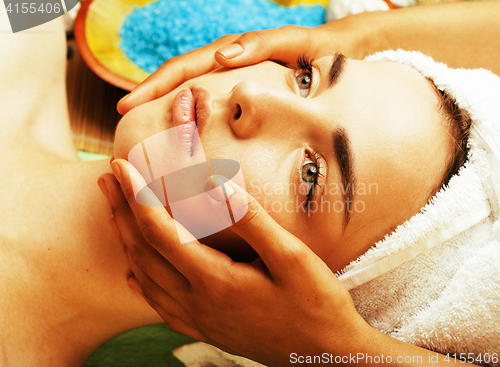 Image of stock photo attractive lady getting spa treatment in salon, close up asian hands on face