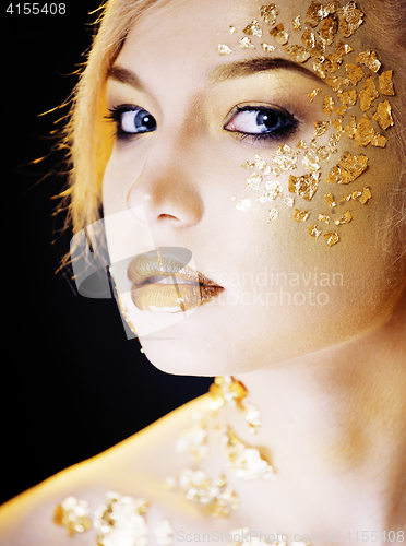 Image of beauty blond woman with gold creative make up, bokeh on yellow background