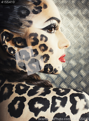 Image of young sexy woman with leopard make up all over body, cat bodyart