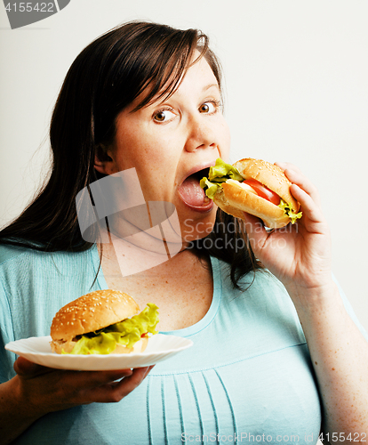 Image of fat white woman having choice between hamburger and salad