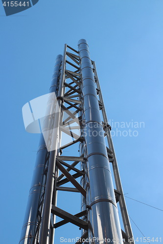 Image of  smokestack is shooting into the clear sky