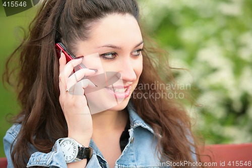 Image of brunette speaks on telephone