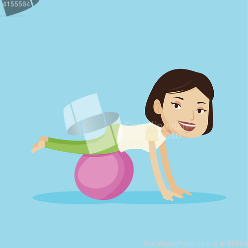 Image of Young woman exercising with fitball.