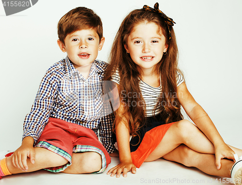 Image of little cute boy and girl hugging playing on white background, ha