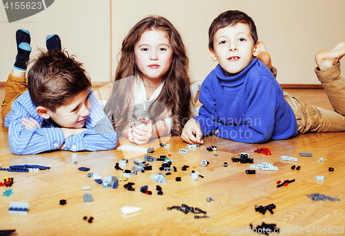 Image of funny cute children playing lego at home, boys and girl smiling, first education role lifestyle