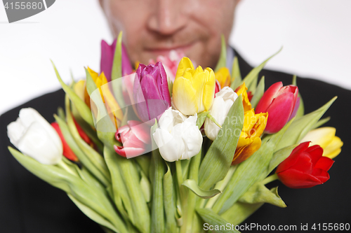 Image of Male hand with bouquet of tulips, isolated