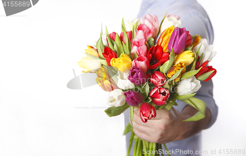 Image of Male hand with bouquet of tulips, isolated