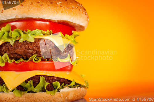Image of Tasty and appetizing hamburger on a yellow