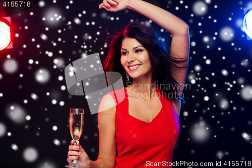 Image of beautiful woman with champagne glass at nightclub