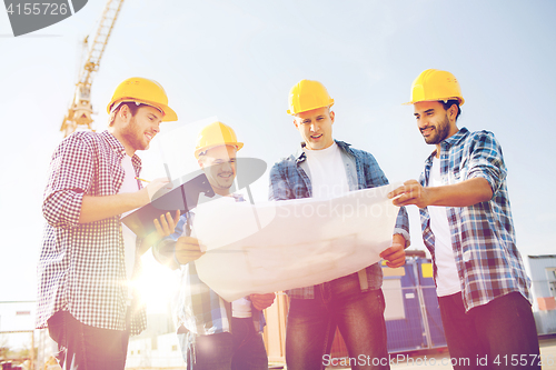 Image of group of builders with tablet pc and blueprint