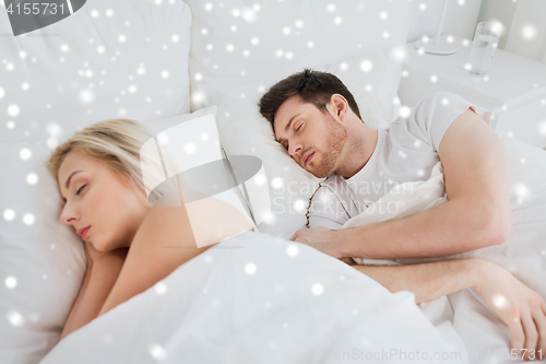 Image of happy couple sleeping in bed at home