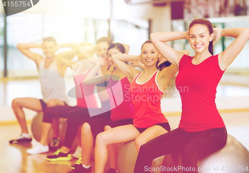 Image of group of people working out in pilates class