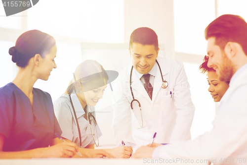 Image of group of happy doctors meeting at hospital office