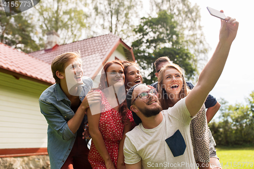 Image of friends taking selfie at party in summer garden