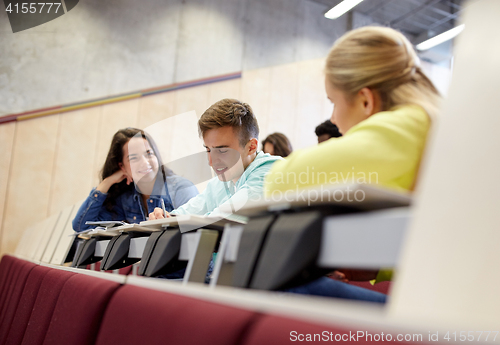 Image of group of students with notebooks at lecture hall