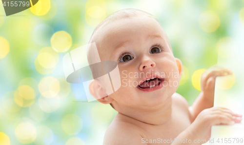 Image of happy little baby boy or girl looking up