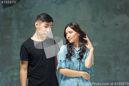 Image of Portrait of smiling Korean couple on a gray