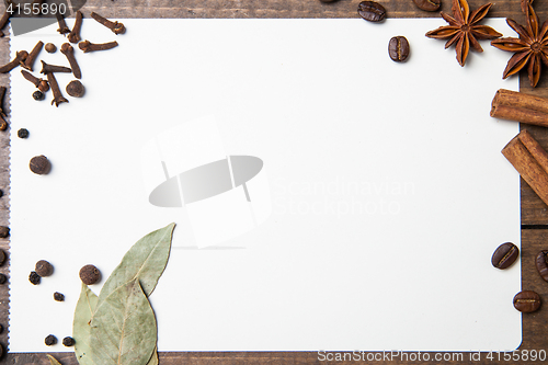 Image of paper for recipes and spices on wooden table