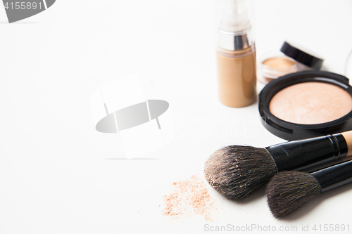 Image of Powder, foundation and brushes on the white background