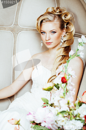 Image of beauty young bride alone in luxury vintage interior with a lot of flowers close up