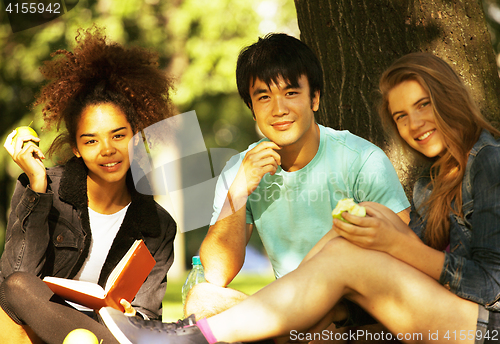 Image of cute group of teenages at the building of university with books huggings