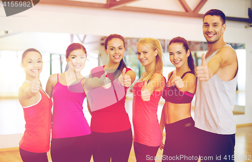 Image of group of people in the gym showing thumbs up