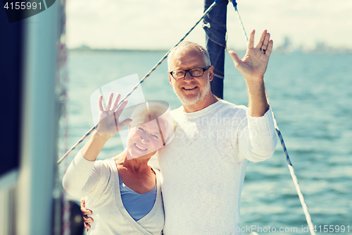 Image of senior couple hugging on sail boat or yacht in sea