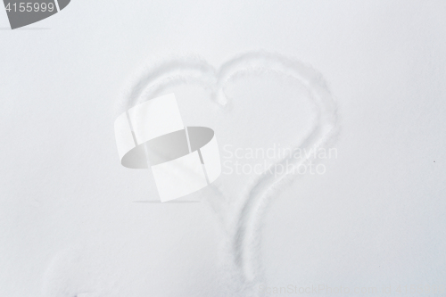 Image of heart shape silhouette or print on snow surface