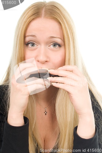 Image of beautiful blond woman with a harmonica