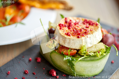 Image of goat cheese salad with vegetables at restaurant