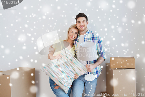 Image of happy couple with stuff moving to new home