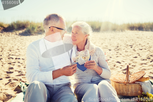 Image of happy senior couple talking on summer beach