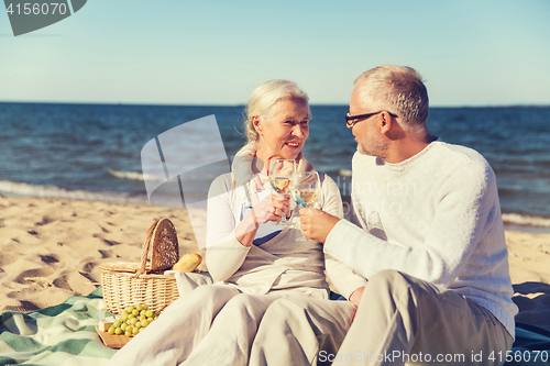 Image of happy senior couple talking on summer beach
