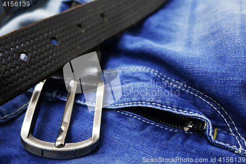 Image of Blue jeans with black leather belt